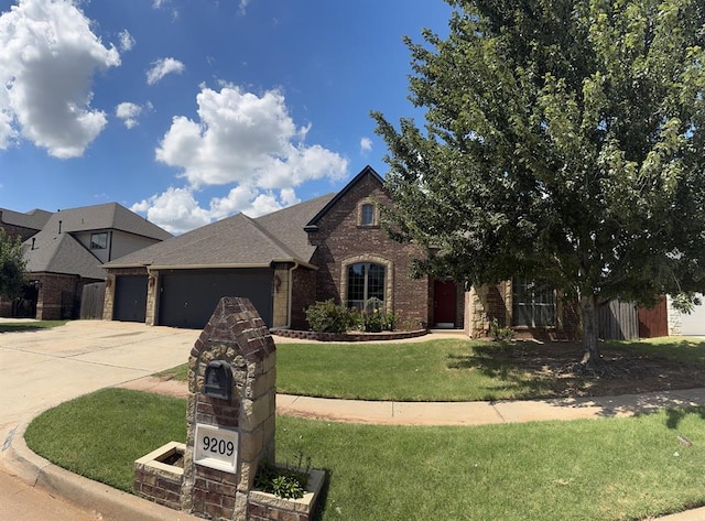 9209 SW 28th St, Oklahoma City, OK 73128 - view of front of home featuring a garage, brick siding, concrete driveway, a front yard, and a shingled roof