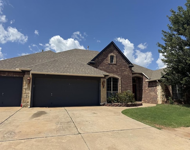 9209 SW 28th St, Oklahoma City, OK 73128 - view of front of property featuring roof with shingles, concrete driveway, and a garage