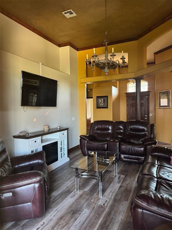 9209 SW 28th St, Oklahoma City, OK 73128 - living room featuring ornamental molding, wood finished floors, and a chandelier