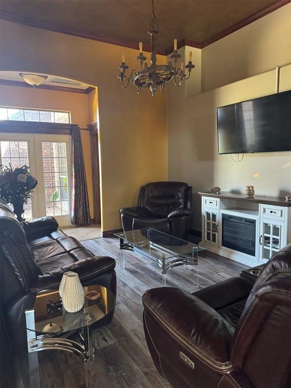 9209 SW 28th St, Oklahoma City, OK 73128 - living area with a chandelier, crown molding, and wood finished floors
