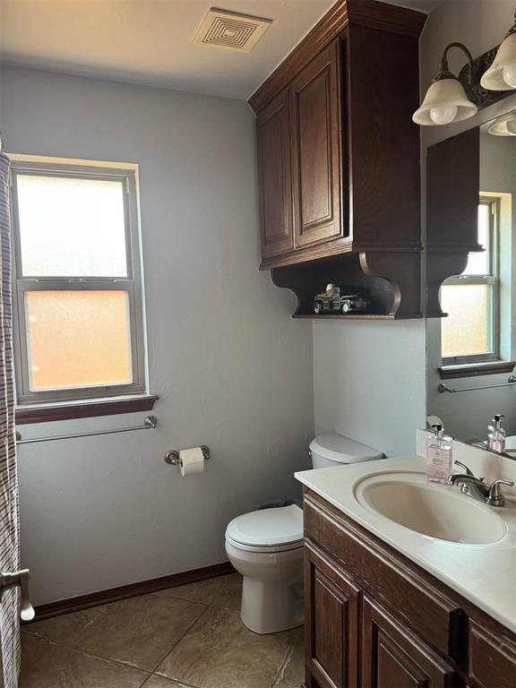 9209 SW 28th St, Oklahoma City, OK 73128 - bathroom with plenty of natural light, vanity, and tile patterned flooring