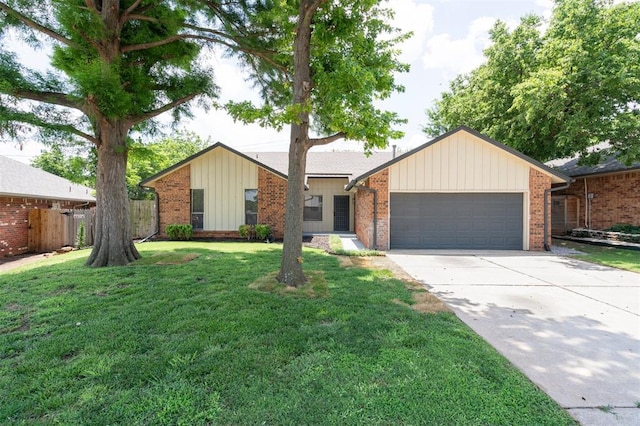 2322 Ripple Creek Ln, Edmond, OK 73012 - view of front facade featuring an attached garage, driveway, brick siding, and board and batten siding