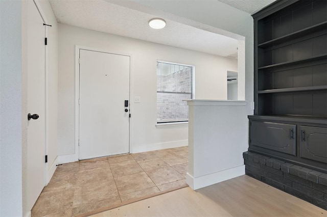 2322 Ripple Creek Ln, Edmond, OK 73012 - foyer featuring a textured ceiling and baseboards