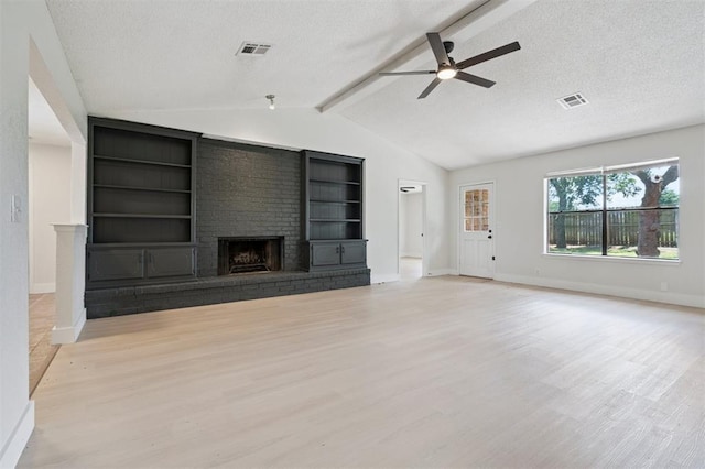 2322 Ripple Creek Ln, Edmond, OK 73012 - unfurnished living room featuring light wood finished floors, a ceiling fan, a brick fireplace, a textured ceiling, and built in shelves