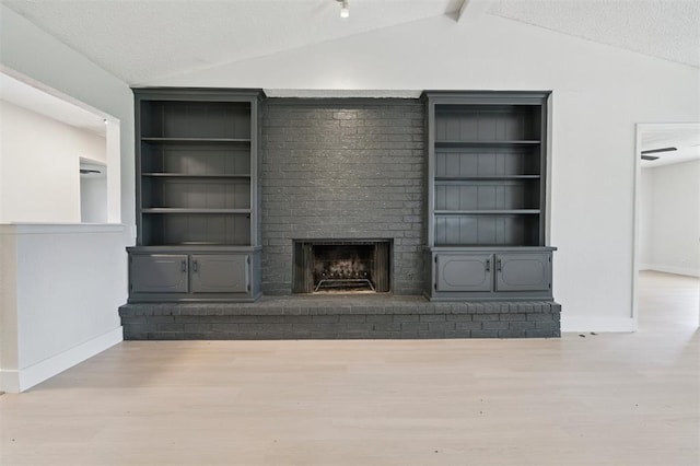 2322 Ripple Creek Ln, Edmond, OK 73012 - unfurnished living room with vaulted ceiling, wood finished floors, and a fireplace