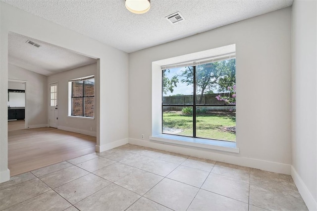 2322 Ripple Creek Ln, Edmond, OK 73012 - unfurnished room with light tile patterned floors and a textured ceiling