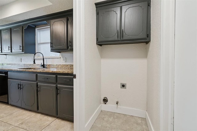 2322 Ripple Creek Ln, Edmond, OK 73012 - laundry room featuring gas dryer hookup, electric dryer hookup, light tile patterned floors, and cabinet space