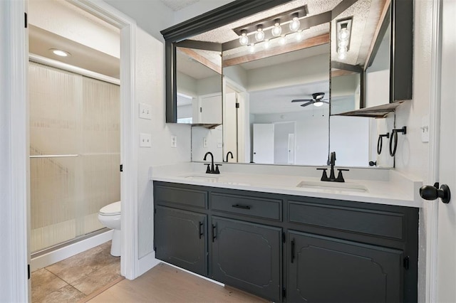 2322 Ripple Creek Ln, Edmond, OK 73012 - bathroom featuring double vanity, ceiling fan, and a shower stall