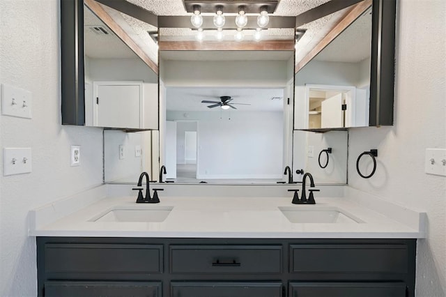 2322 Ripple Creek Ln, Edmond, OK 73012 - bathroom with double vanity, ceiling fan, and a textured wall