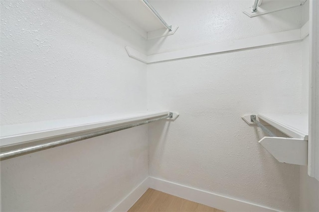 2322 Ripple Creek Ln, Edmond, OK 73012 - walk in closet with light wood-type flooring