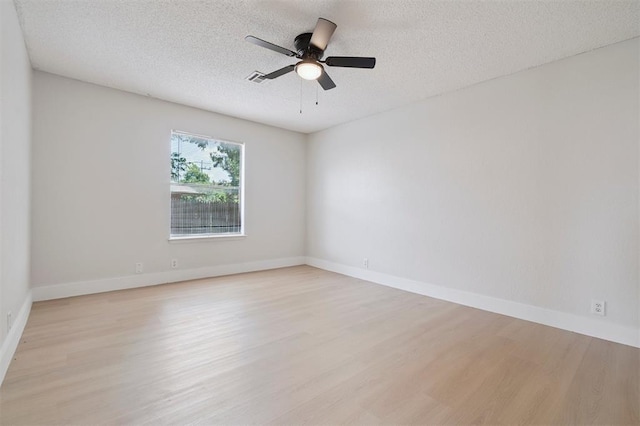 2322 Ripple Creek Ln, Edmond, OK 73012 - spare room with light wood-style floors, ceiling fan, and a textured ceiling
