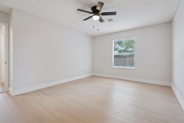 2322 Ripple Creek Ln, Edmond, OK 73012 - empty room featuring light wood-style flooring, ceiling fan, and a textured ceiling