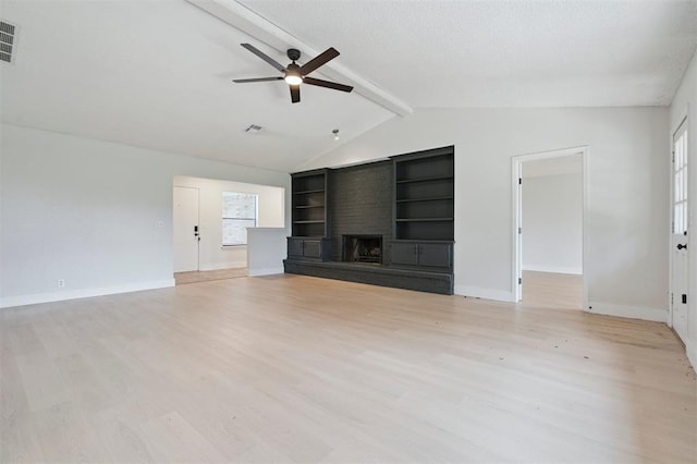 2322 Ripple Creek Ln, Edmond, OK 73012 - unfurnished living room with a ceiling fan, light wood-style flooring, a fireplace, and built in features
