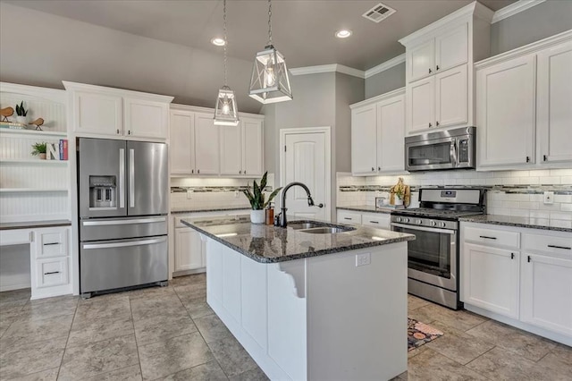 18608 Summer Grove Ave, Edmond, OK 73012 - kitchen featuring appliances with stainless steel finishes, crown molding, decorative backsplash, white cabinets, and recessed lighting