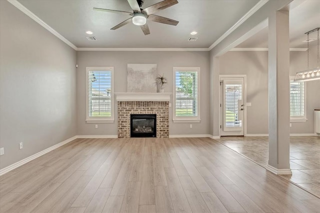 18608 Summer Grove Ave, Edmond, OK 73012 - unfurnished living room featuring light wood-style flooring, a ceiling fan, a fireplace, ornamental molding, and recessed lighting