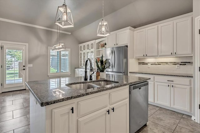 18608 Summer Grove Ave, Edmond, OK 73012 - kitchen with stainless steel appliances, a center island with sink, lofted ceiling, light tile patterned floors, and decorative backsplash