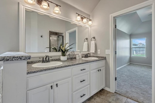 18608 Summer Grove Ave, Edmond, OK 73012 - full bath with vaulted ceiling, double vanity, a stall shower, and tile patterned flooring