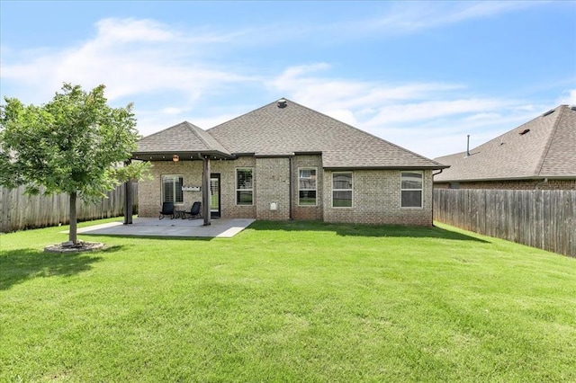 18608 Summer Grove Ave, Edmond, OK 73012 - rear view of property with a shingled roof, brick siding, a fenced backyard, and a patio