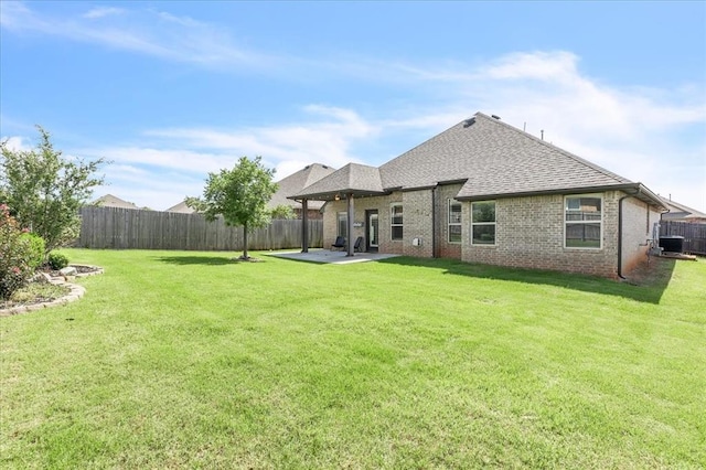 18608 Summer Grove Ave, Edmond, OK 73012 - rear view of property with a shingled roof, a fenced backyard, a patio area, and brick siding
