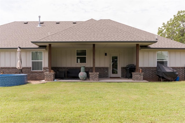 337030 E 1016th Rd, Meeker, OK 74855 - back of house featuring a shingled roof, board and batten siding, brick siding, and a yard