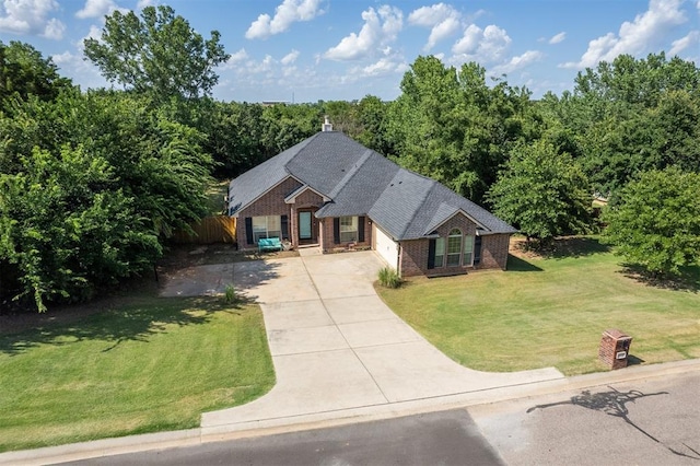 3751 Rock Dove Lndg, Edmond, OK 73034 - view of front facade with concrete driveway, brick siding, and a garage