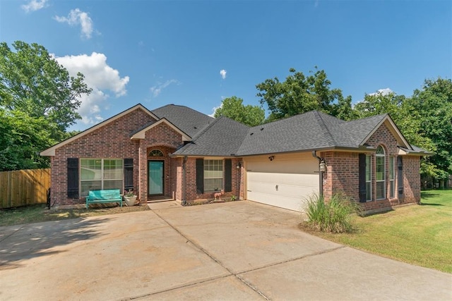 3751 Rock Dove Lndg, Edmond, OK 73034 - view of front facade with brick siding, a garage, driveway, and roof with shingles