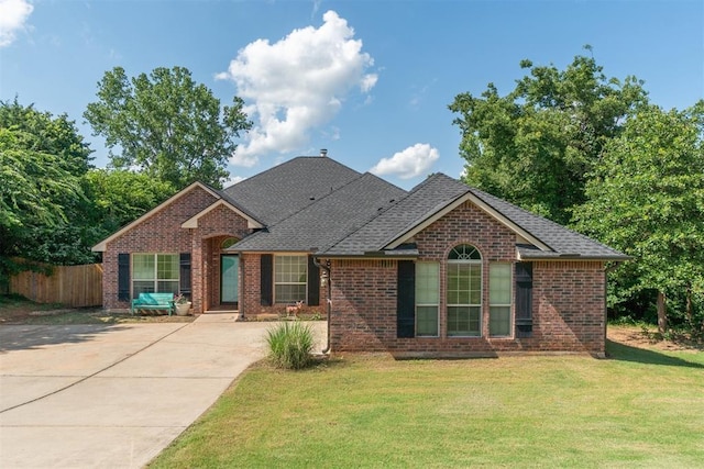 3751 Rock Dove Lndg, Edmond, OK 73034 - view of front facade featuring brick siding, concrete driveway, and roof with shingles