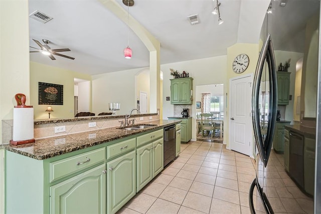 3751 Rock Dove Lndg, Edmond, OK 73034 - kitchen with green cabinetry, light tile patterned flooring, dishwasher, arched walkways, and ceiling fan