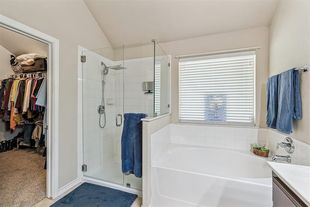 3751 Rock Dove Lndg, Edmond, OK 73034 - full bath featuring a garden tub, a stall shower, a spacious closet, lofted ceiling, and vanity