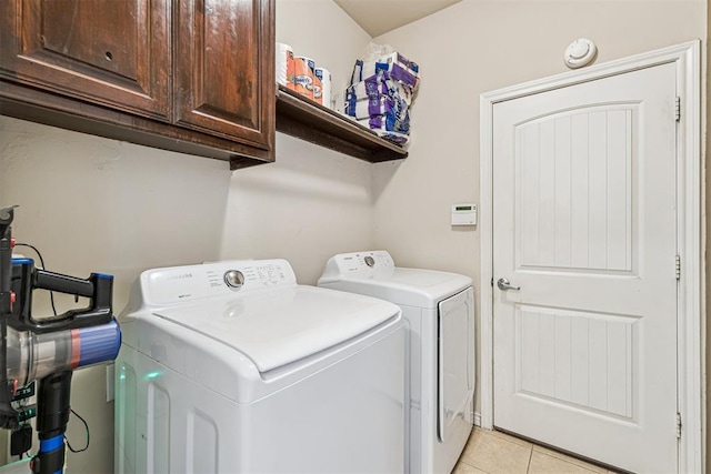 3751 Rock Dove Lndg, Edmond, OK 73034 - washroom with washing machine and clothes dryer, cabinet space, and light tile patterned floors