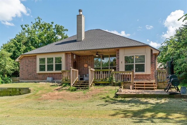 3751 Rock Dove Lndg, Edmond, OK 73034 - rear view of house with ceiling fan, brick siding, a lawn, and a chimney