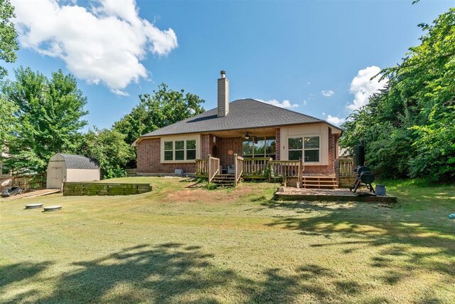 3751 Rock Dove Lndg, Edmond, OK 73034 - back of property with a storage shed, ceiling fan, a yard, and a deck