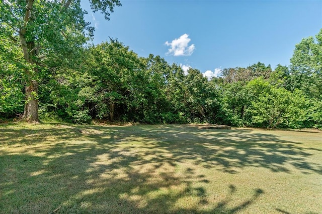 3751 Rock Dove Lndg, Edmond, OK 73034 - view of grassy yard with a wooded view