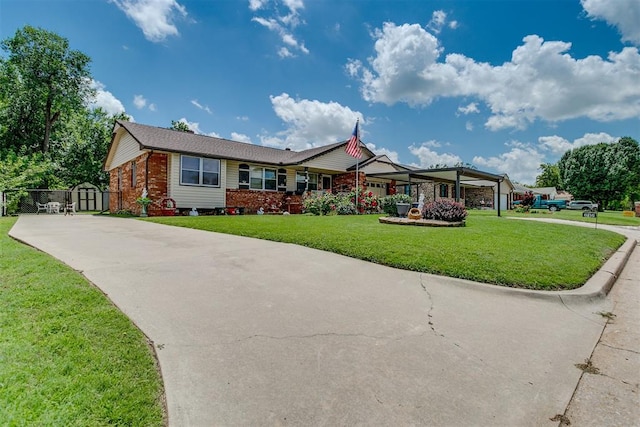 616 Kingston Dr, Yukon, OK 73099 - ranch-style house with a storage shed, a front yard, brick siding, and concrete driveway