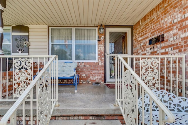 616 Kingston Dr, Yukon, OK 73099 - view of exterior entry with a porch and brick siding