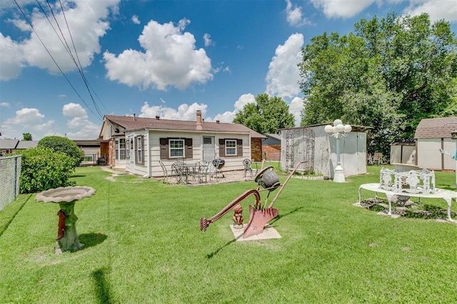616 Kingston Dr, Yukon, OK 73099 - back of house featuring a shed, a patio area, and a chimney