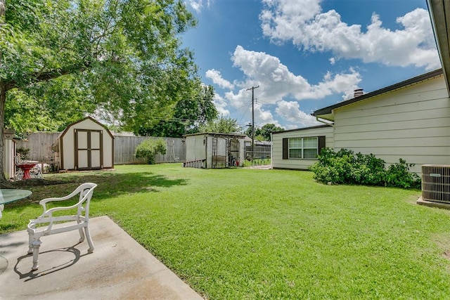 616 Kingston Dr, Yukon, OK 73099 - fenced backyard with a storage unit and a patio
