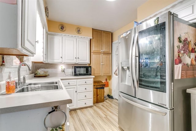 616 Kingston Dr, Yukon, OK 73099 - kitchen with stainless steel refrigerator with ice dispenser, black microwave, light wood-type flooring, light countertops, and white cabinetry