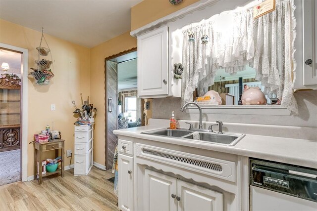 616 Kingston Dr, Yukon, OK 73099 - kitchen with dishwasher, light wood-style floors, white cabinetry, and light countertops