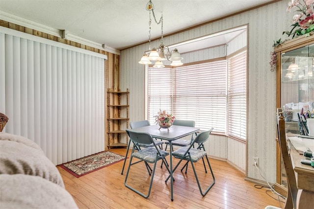 616 Kingston Dr, Yukon, OK 73099 - dining room with wallpapered walls, light wood finished floors, and a chandelier
