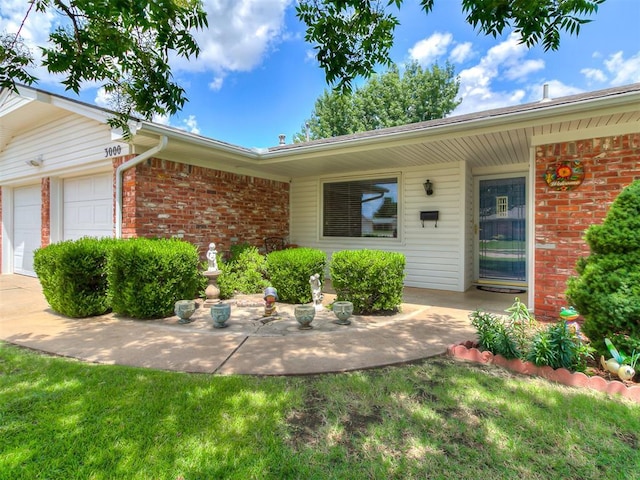3000 Beverly Dr, Edmond, OK 73013 - view of front of property featuring brick siding and an attached garage
