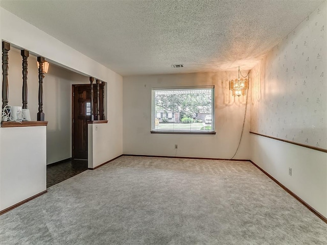 3000 Beverly Dr, Edmond, OK 73013 - spare room featuring carpet, a textured ceiling, and a chandelier