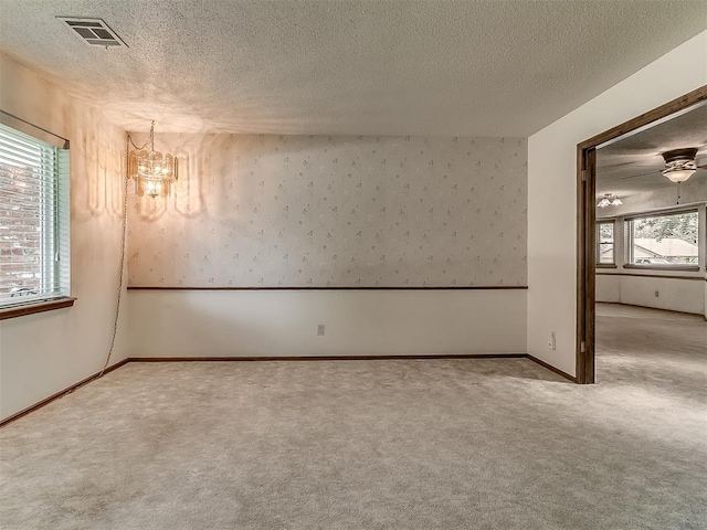 3000 Beverly Dr, Edmond, OK 73013 - spare room with a chandelier, carpet flooring, and a textured ceiling