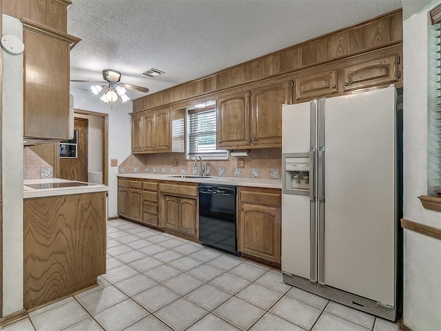 3000 Beverly Dr, Edmond, OK 73013 - kitchen with black appliances, light countertops, tasteful backsplash, a ceiling fan, and a textured ceiling