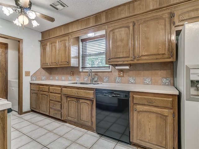 3000 Beverly Dr, Edmond, OK 73013 - kitchen featuring dishwasher, white fridge with ice dispenser, light countertops, and a textured ceiling
