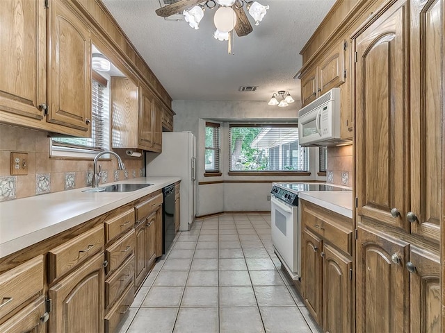 3000 Beverly Dr, Edmond, OK 73013 - kitchen with white appliances, light countertops, tasteful backsplash, light tile patterned flooring, and a textured ceiling