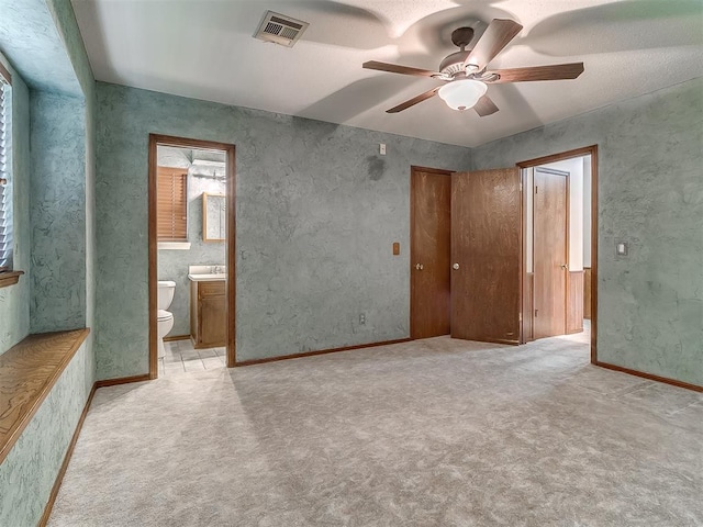 3000 Beverly Dr, Edmond, OK 73013 - unfurnished bedroom featuring light colored carpet, ensuite bath, and ceiling fan