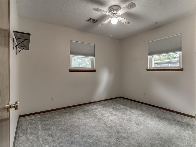 3000 Beverly Dr, Edmond, OK 73013 - empty room with healthy amount of natural light, a textured ceiling, carpet floors, and ceiling fan