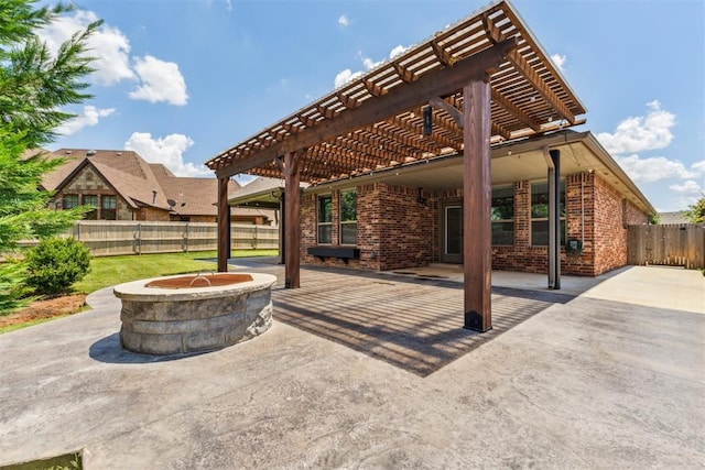 9041 NW 147th Ter, Yukon, OK 73099 - fenced backyard with a fire pit, a patio, and a pergola