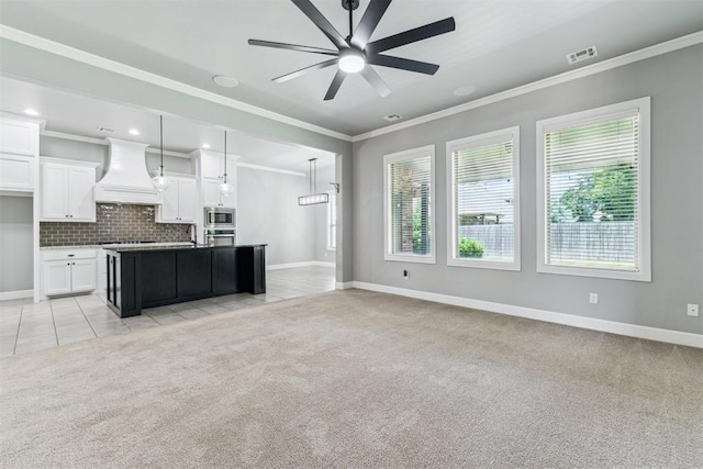9041 NW 147th Ter, Yukon, OK 73099 - kitchen featuring premium range hood, appliances with stainless steel finishes, light carpet, open floor plan, and crown molding